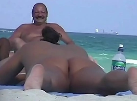 Stripped breasty honey widens legs at the beach